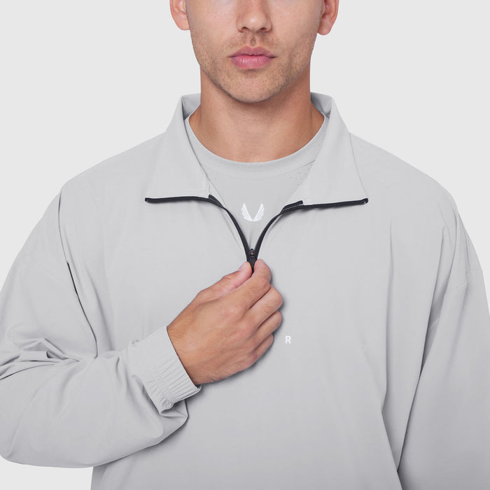 Aerotex Quarter-Zip Jacket in Slate Grey, modeled from chest up with hand on zipper