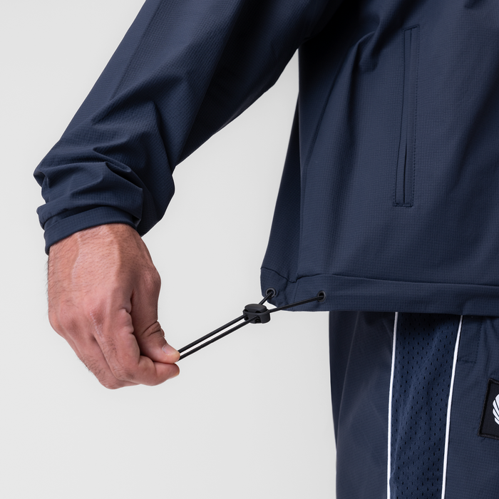 Navy ripstop quarter zip jacket worn by model, closeup of drawstring detail