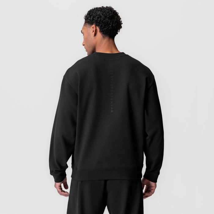 Black herringbone terry crewneck worn by model, back view