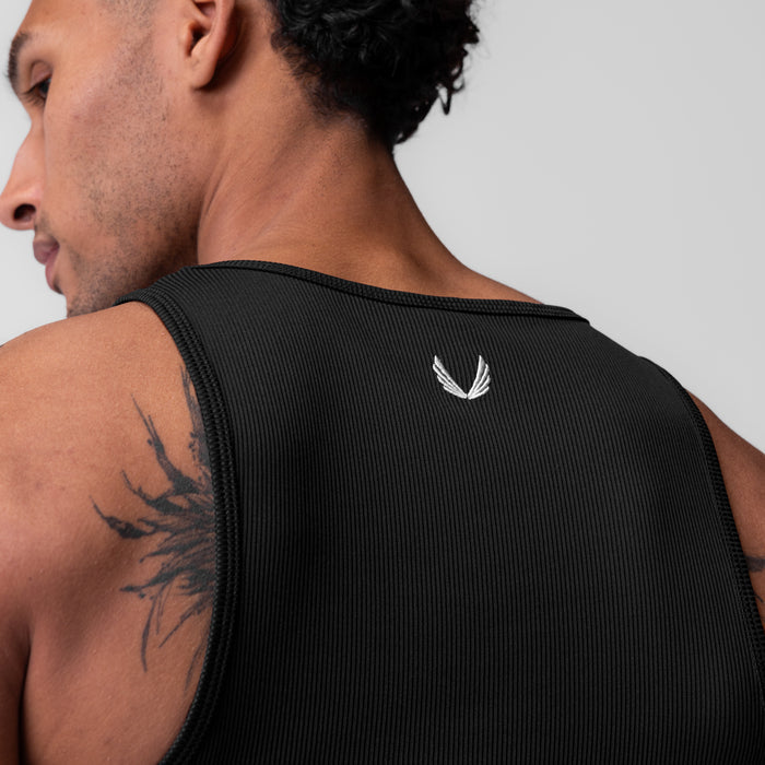 Black Creora® Tech Ribbed Tank worn by model, rear view showing logo detail