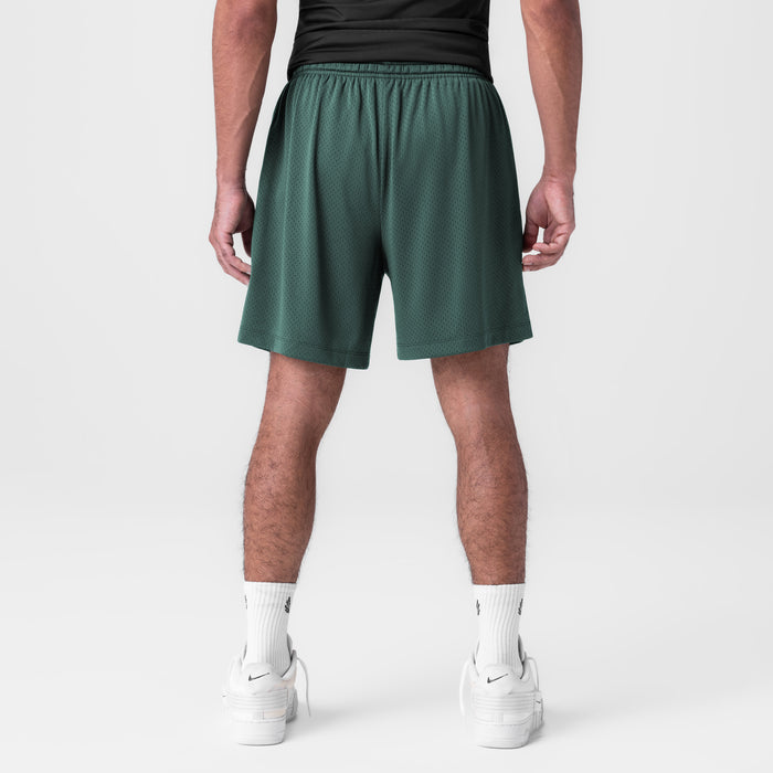 Reversible 2-in-1 shorts in forest green worn by model, back view