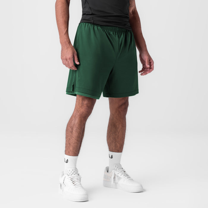 Reversible 2-in-1 Short in forest green worn by model with white sneakers, front view