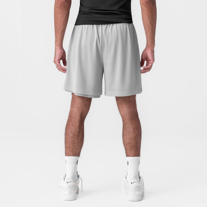 Reversible 2-in-1 shorts in slate grey worn by model, back view