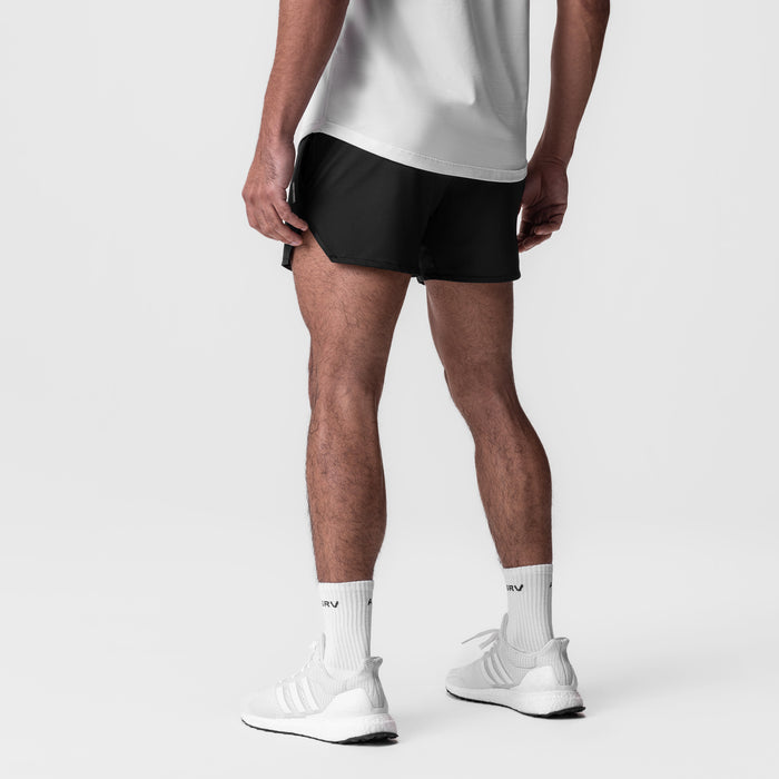 AeroSilver 5" Linerless Short in black, worn with white socks and sneakers, back view