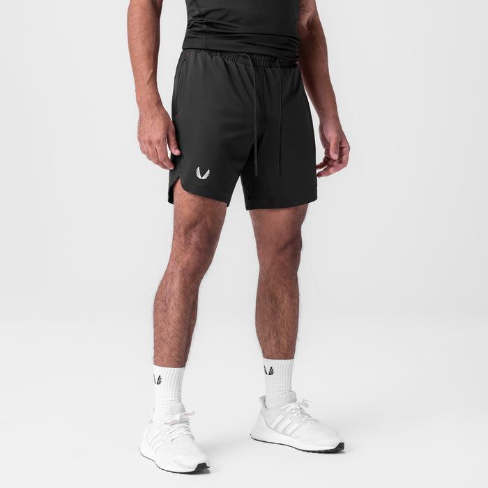 AeroSilver 7" Linerless Short in black, modeled with white socks and sneakers