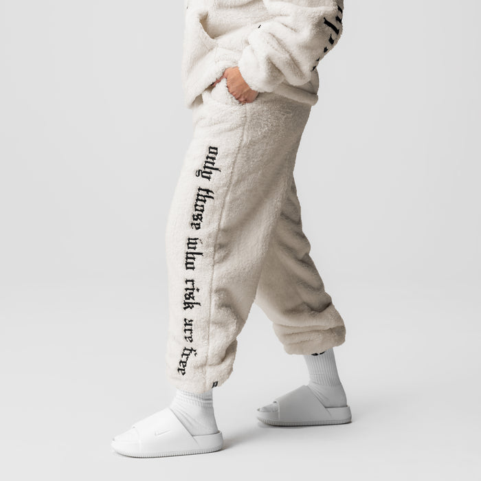 Womens Sherpa Recovery Sweats in ivory cream with black text, worn by model showing side view