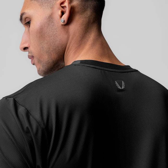 AeroSilver Essential Tee in black, worn by model shown from side profile