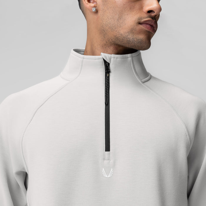 Dri-Core Quarter Zip in light grey worn by model, front view showing zippered neckline