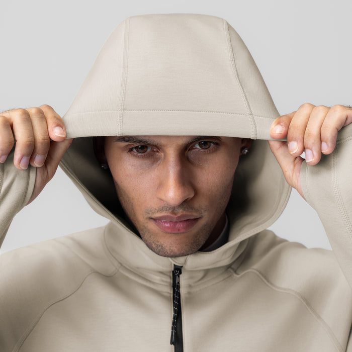 Dri-Core™ Zip Hoodie in Chai, worn by model with hood pulled up