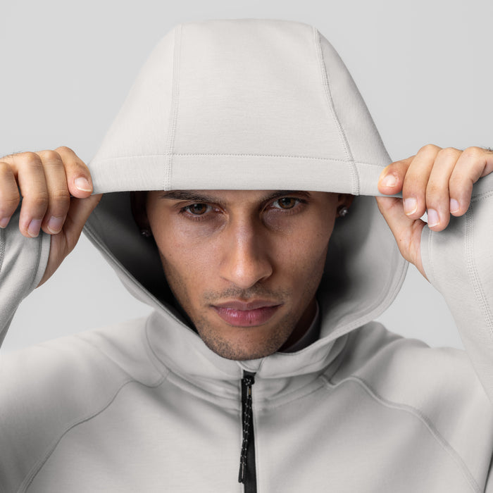 Dri-Core™ Zip Hoodie in light grey worn by model with hood pulled up, front view