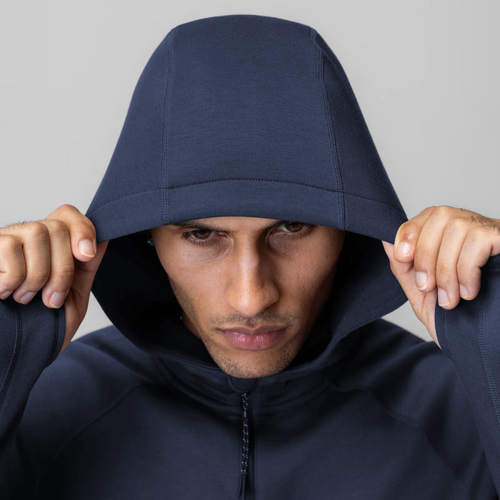 Dri-Core™ Zip Hoodie in navy worn by model with hood pulled up over head