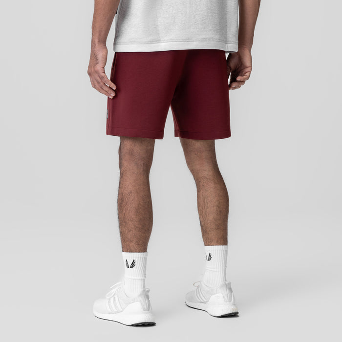 Dri-Core Training Short in crimson, modeled from behind with white socks and sneakers
