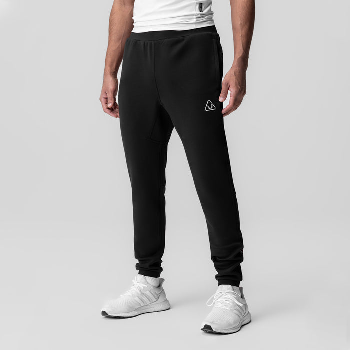Black Dri-Core Training Jogger worn by model with white sneakers, front view
