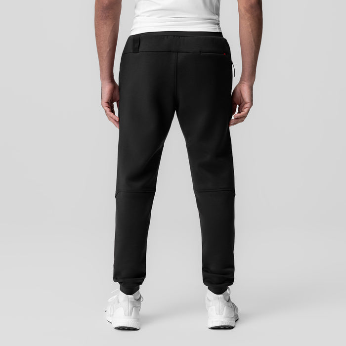 Dri-Core Training Jogger in black, back view on model wearing white sneakers