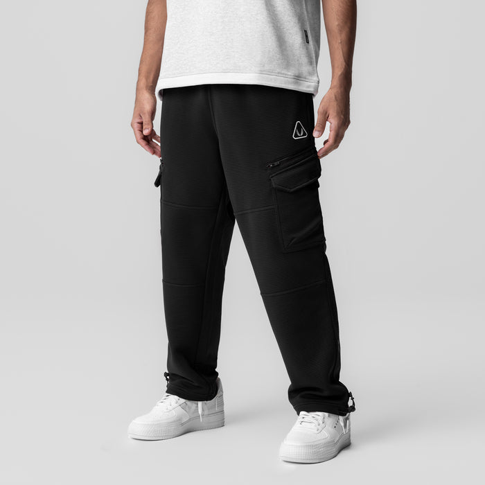 Black Deltapeak Cargo Cinch Jogger worn by model with white sneakers, front view