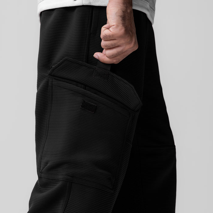 Deltapeak® Cargo Cinch Jogger in black, worn with hand in pocket detail