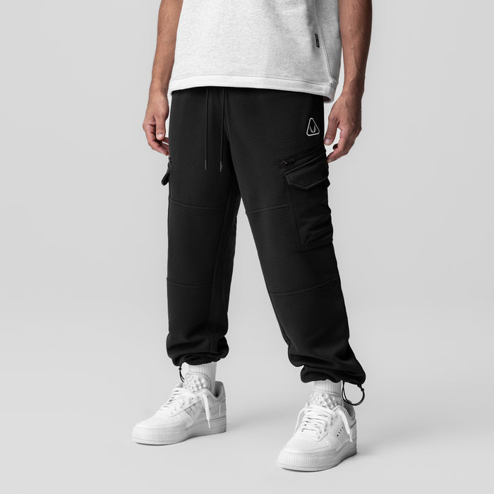 Deltapeak® Cargo Cinch Jogger in black worn by model with white sneakers, front view