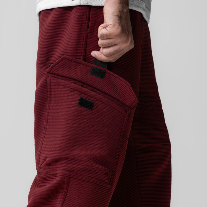 Deltapeak Cargo Cinch Jogger in crimson, model wearing side view showing cargo pockets