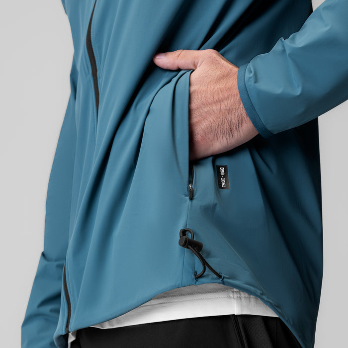 Aerotex Lightweight Windbreaker in storm blue, worn by model with hand in pocket, front view