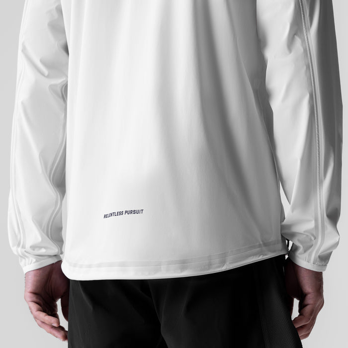 White Aerotex™ Lightweight Windbreaker worn by model, back view showing 'Relentless Pursuit' text