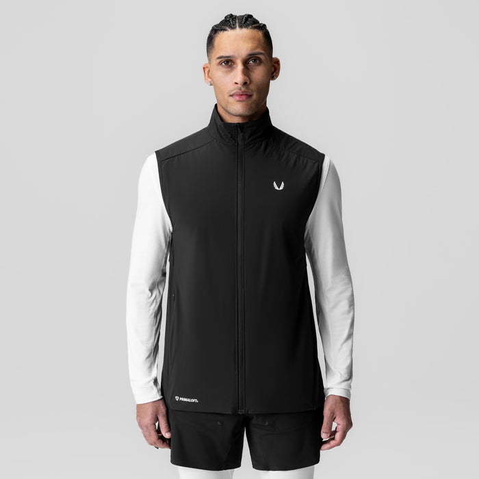 Aerotex PrimaLoft Run Vest in black, worn by male model with white long-sleeve shirt
