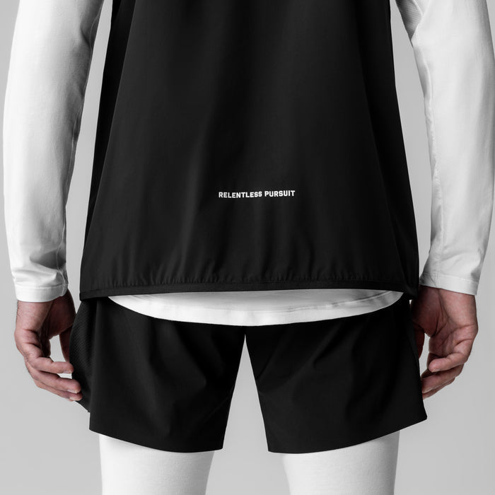 Aerotex PrimaLoft Run Vest in black, back view on model with white long sleeves