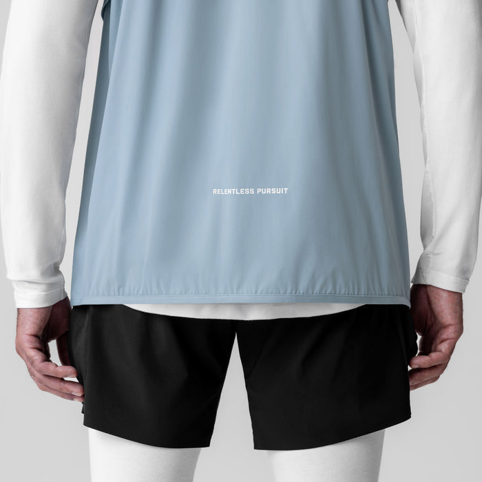 Aerotex PrimaLoft Run Vest in light sky worn with white long sleeve and black shorts, back view