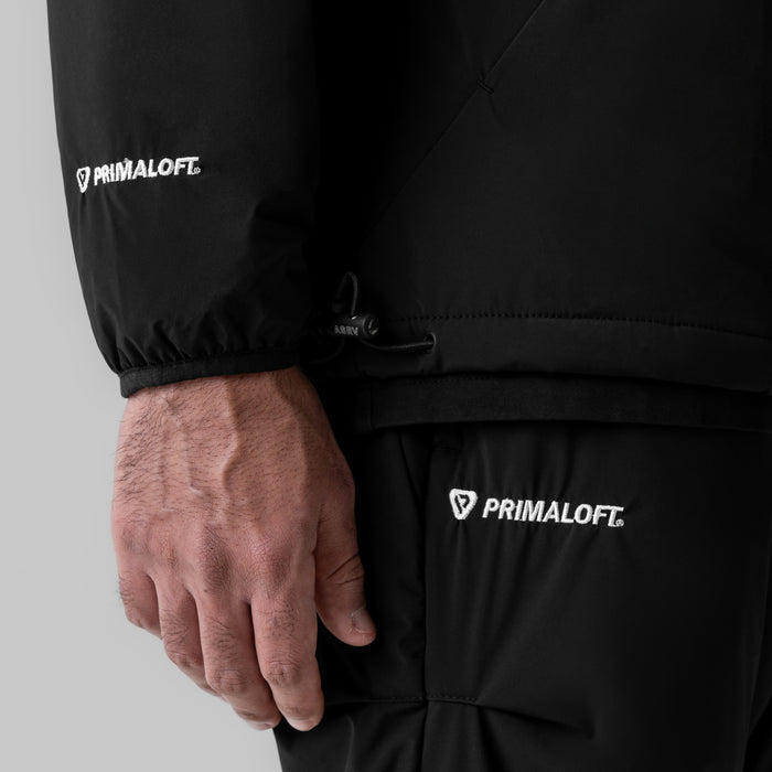 Aerotex™ PrimaLoft® Quarter Zip in black, worn by model showing sleeve detail and branding