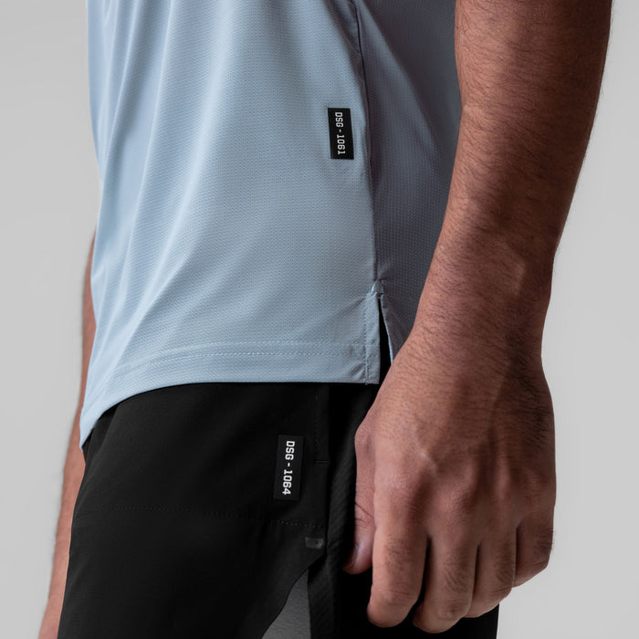 Ice-Skin™ Muscle Tank in light sky worn by model, side view showing fit and fabric