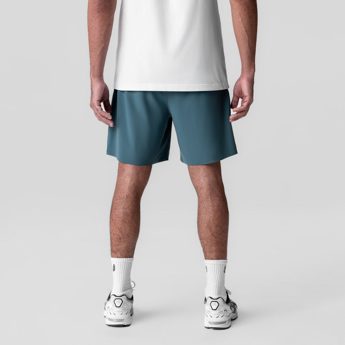 Revolutional Field Short in storm blue, back view on model wearing white tee and white sneakers