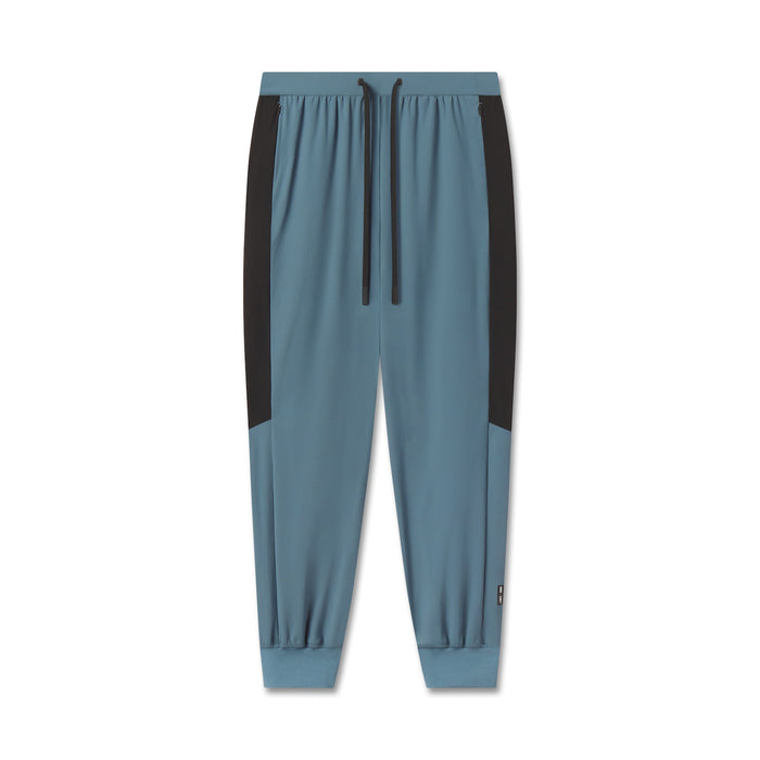 flatlay Tetra-Lite® Cuffed Training Jogger in storm blue with black side panels, front view