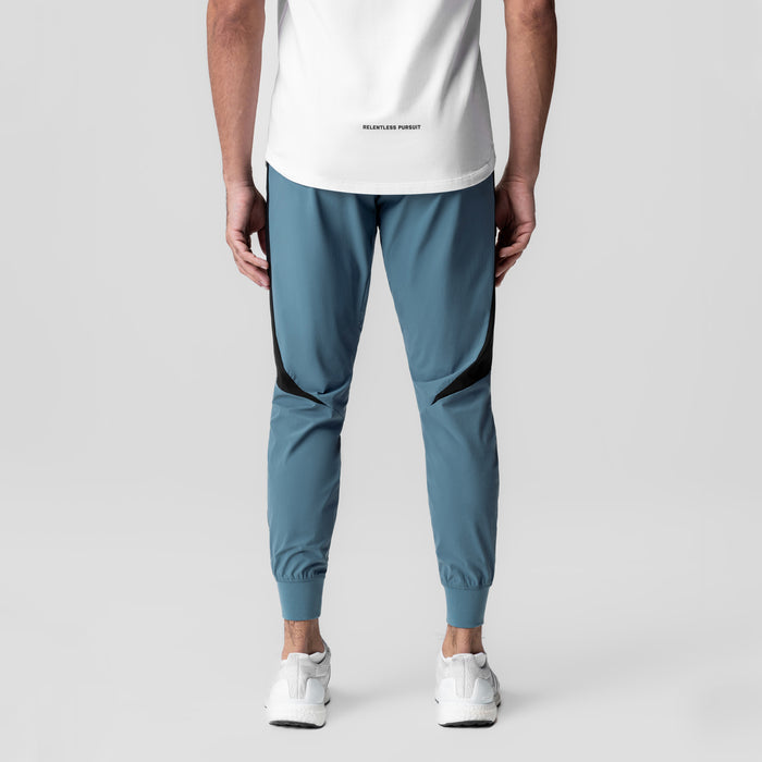 Tetra-Lite® Cuffed Training Jogger in storm blue with black paneling, back view on model