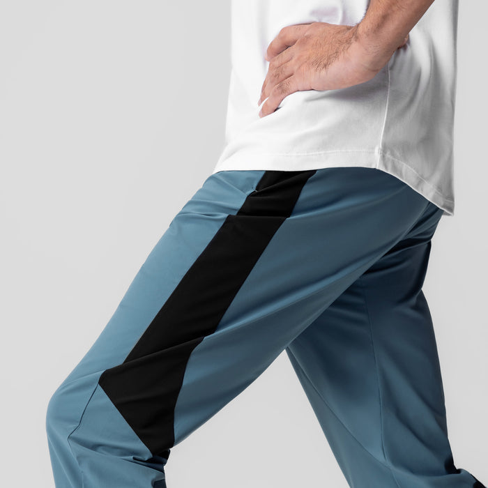 Tetra-Lite Cuffed Training Jogger in storm blue with black stripe, worn by model