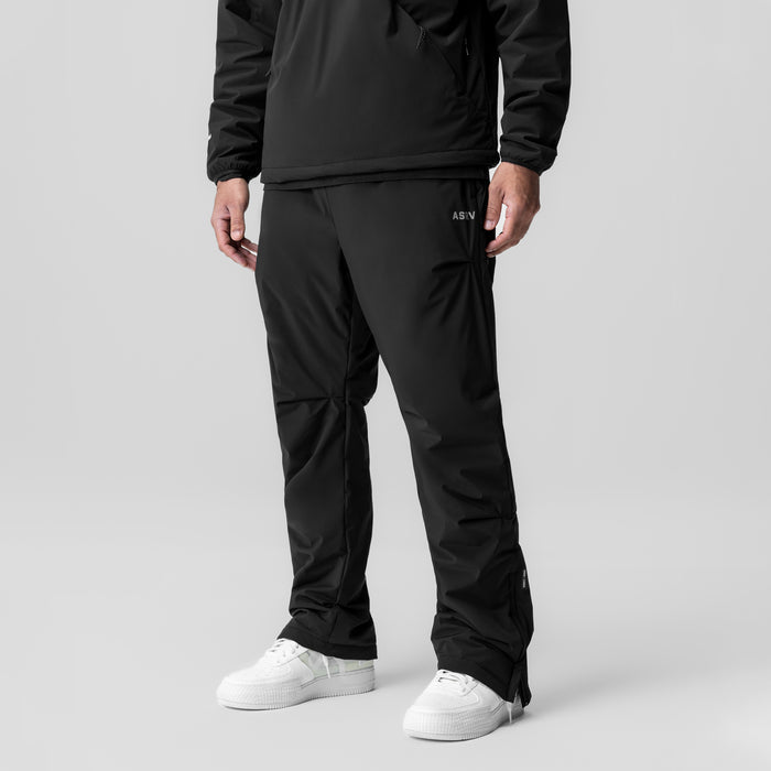 Aerotex™ PrimaLoft® Warm-Up Pant in black, worn with white sneakers, front view