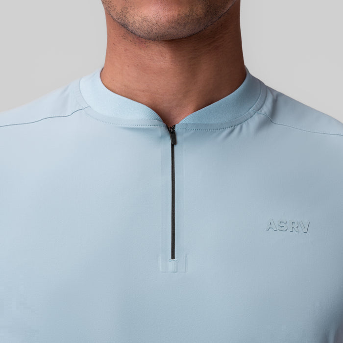 Tetra-Lite® Ice Zip Tee in light sky worn by model, front detail view
