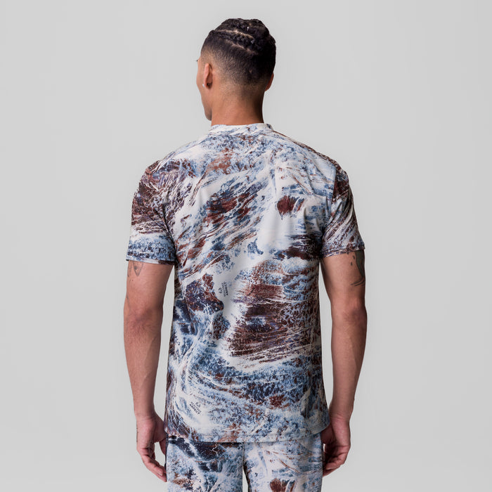 Tetra-Lite Ice Zip Tee in blue/brown marble print, back view on model