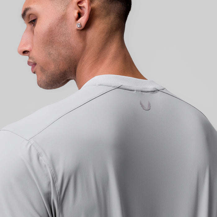 Tetra-Lite Ice Zip Tee in slate grey, worn by model in profile view