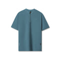 Flatlay of Tetra-Lite Ice Zip Tee in storm blue, front view