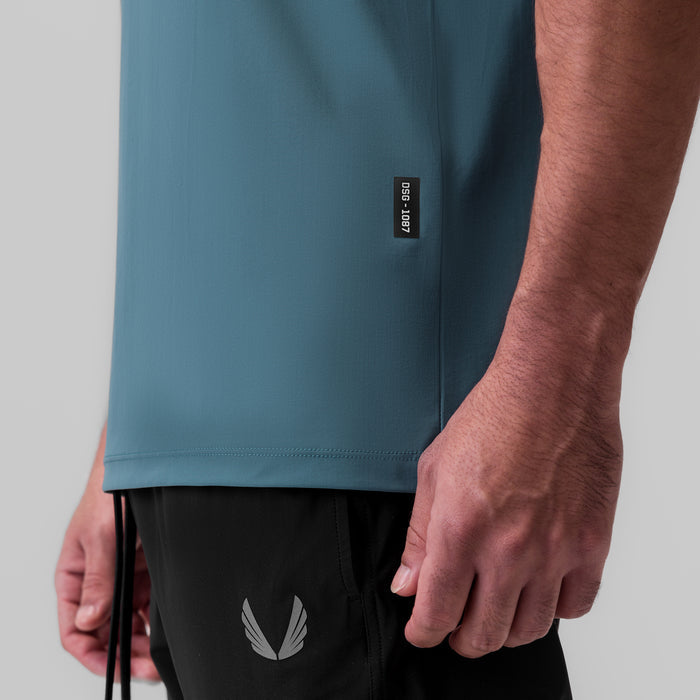 Tetra-Lite Ice Zip Tee in storm blue worn by model, side view detail