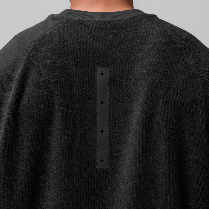 Black Towel Terry Cutoff crewneck worn by model, back view showing button detail