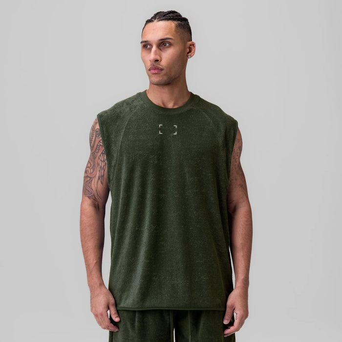 Towel Terry Cutoff sleeveless tank in olive, worn by model facing forward