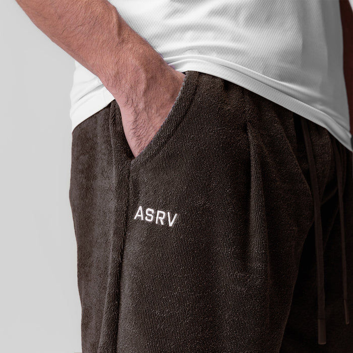 Towel Terry Relaxed Short in Dark Earth worn by model with hand in pocket, front view