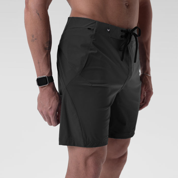 Black Revolutional® Board Short worn by model, side view