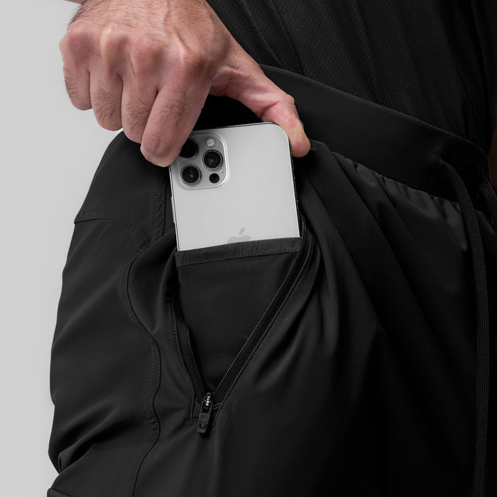 Black Tetra-Lite Ice Cargo High Rib Jogger worn by model, detail of phone in pocket