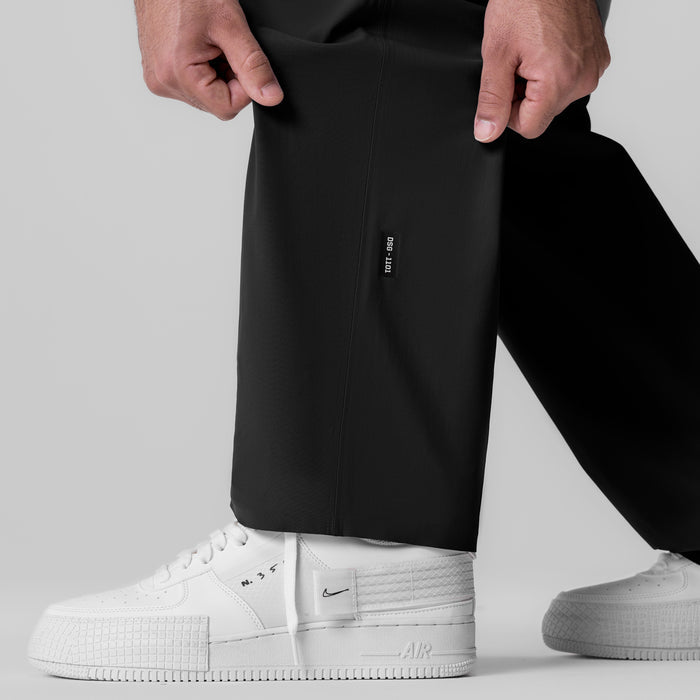 Black Tetra-Lite Field Pant worn with white sneakers, front view detail