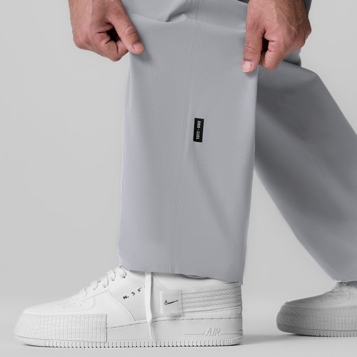 Tetra-Lite Field Pant in slate grey worn with white sneakers, front view