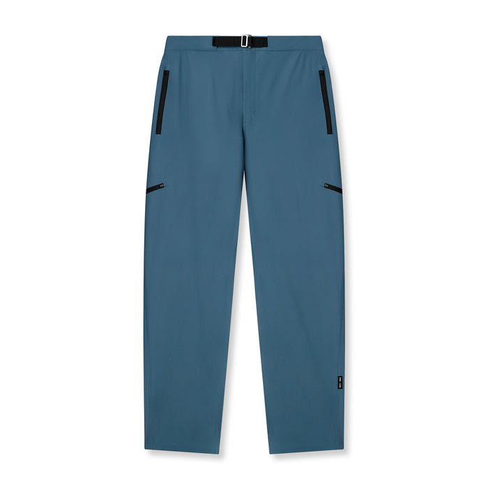 Flatlay of Tetra-Lite Field Pant in storm blue with zip pockets and belt detail