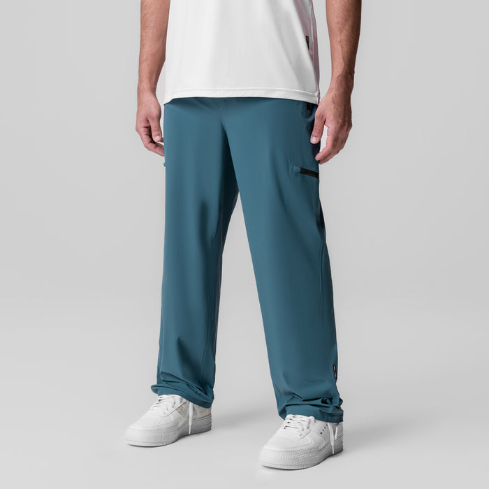 Tetra-Lite Field Pant in Storm blue worn by model with white sneakers, front view
