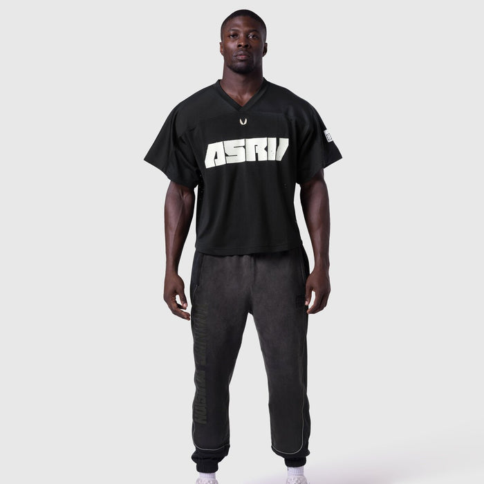 Ion-Mesh Crop Jersey in black with ASTRI text, worn by model with matching joggers, front view