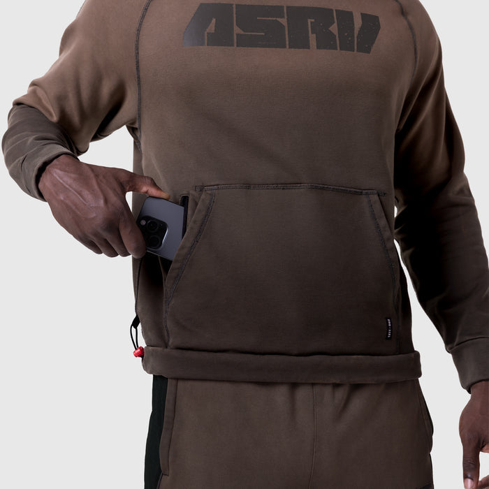 Tech-Terry Training Hoodie in dark earth, worn by model holding phone in front pocket